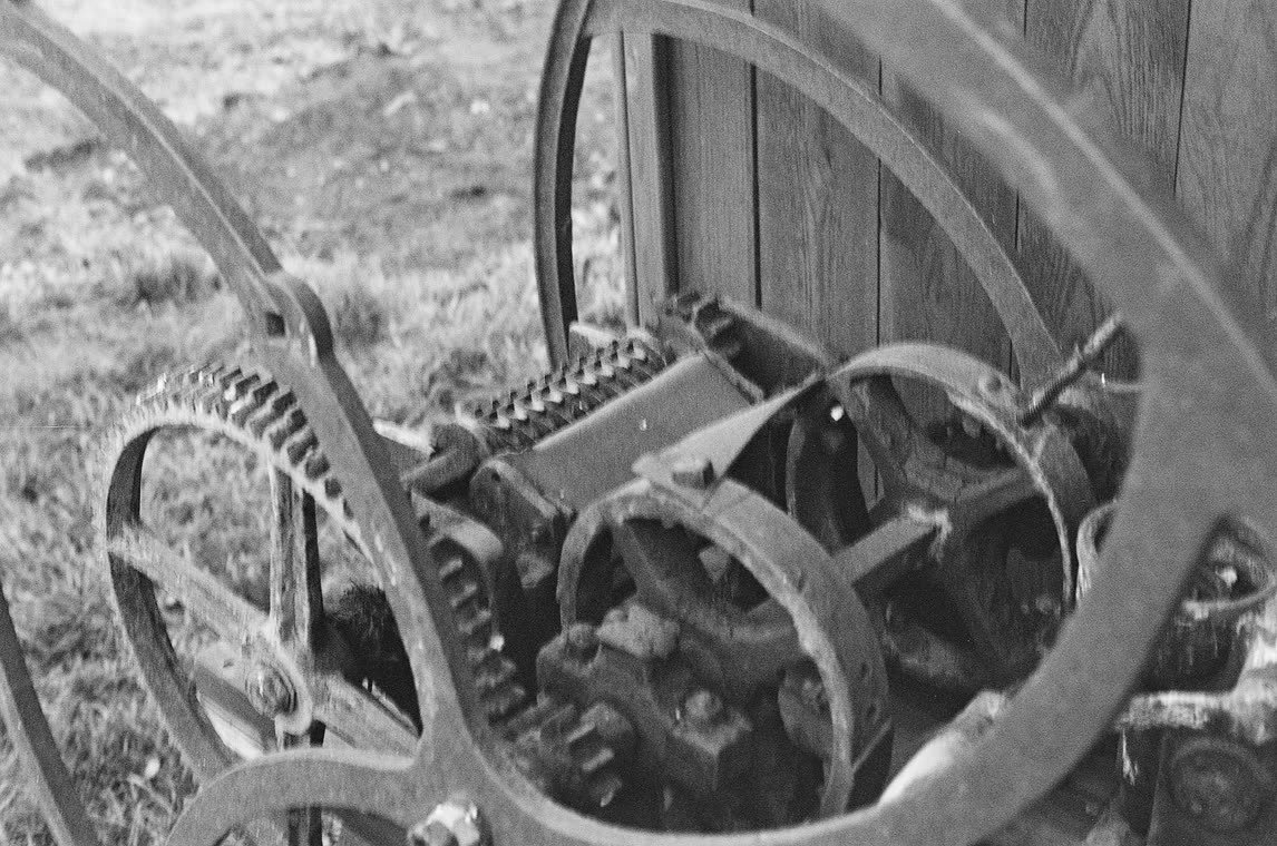 Farm machinery standing in the grass, 35mm