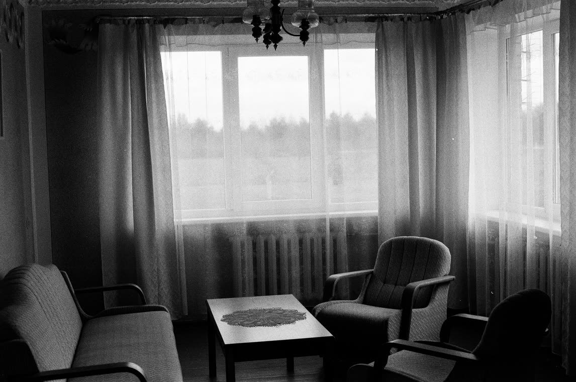Armchairs and a low table at a wide window, 35mm