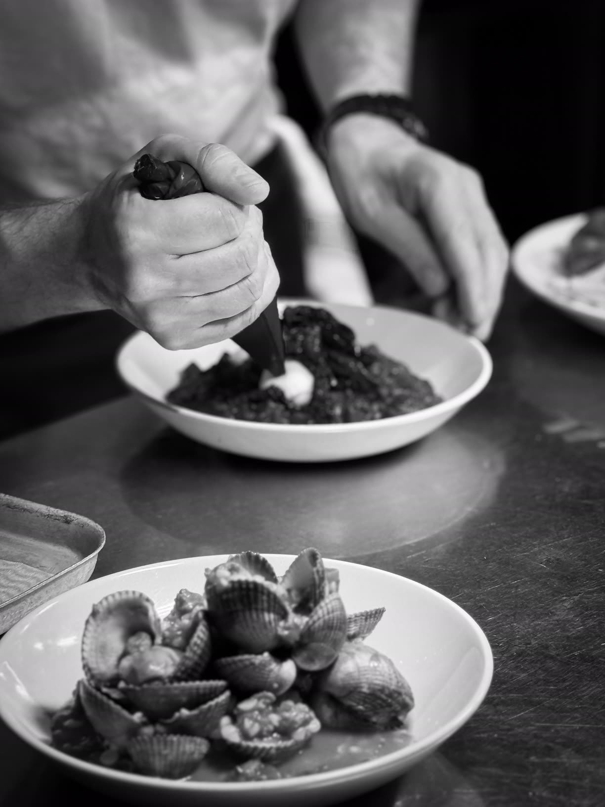 Crabshakk — plating in the kitchen, black and white